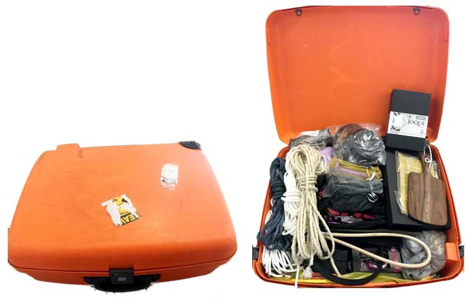 Bright orange suitcase, shown closed, and open full of toys